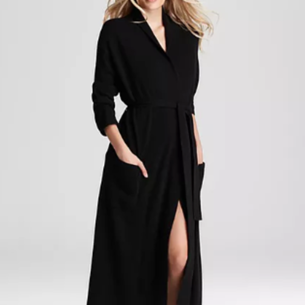 Woman wearing a black dress with a belt on a white background
