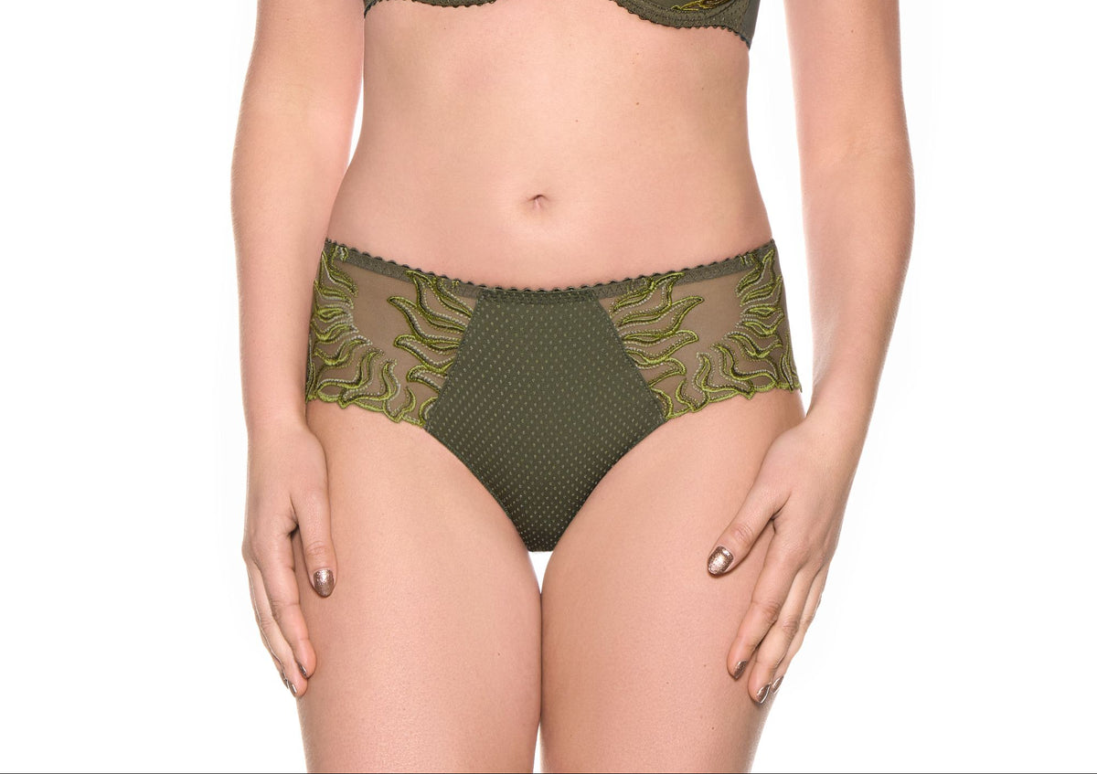 A woman modeling an olive green two-piece lingerie set with green lace trim, consisting of a underwire bra and matching high-waisted briefs, against a plain white background.