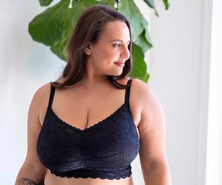 a full figured woman smiles confidently in a wireless bralette