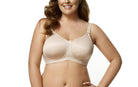 Woman wearing a beige bra and panties set on a white background