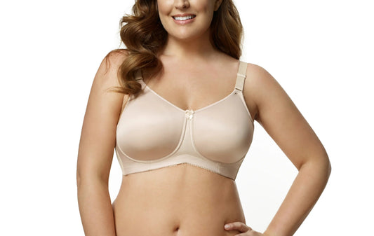 Woman wearing a beige bra and panties set on a white background