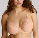 Woman wearing a beige lace bra against a plain background