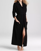 Woman wearing a black dress with a belt on a white background