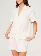 Woman wearing a white outfit on a plain background