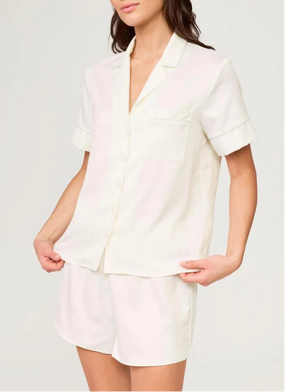 Woman wearing a white outfit on a plain background