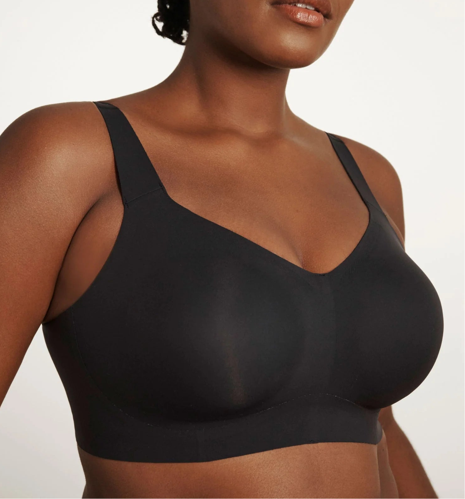 Woman wearing a black sports bra against a plain background