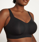 Woman wearing a black sports bra against a plain background