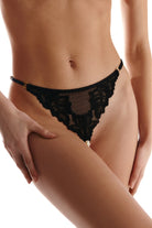 Black lace lingerie worn by a person on a white background