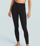 Black leggings worn by a person on a light gray background