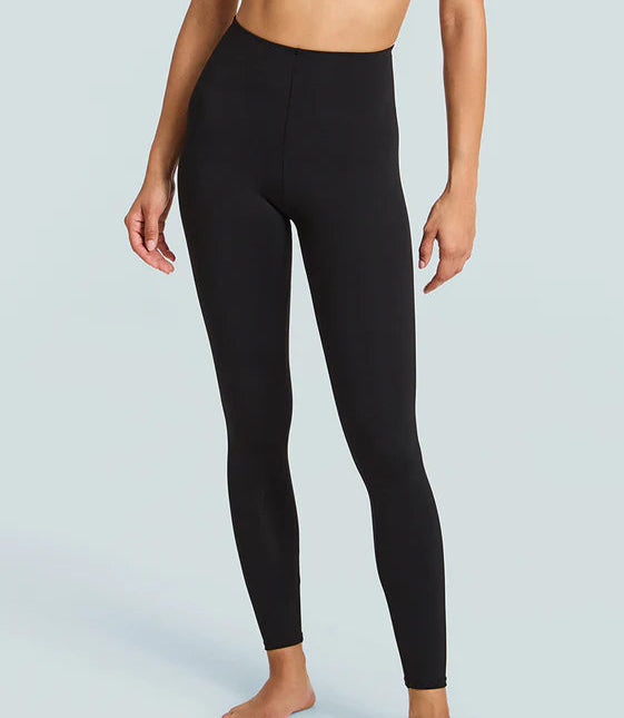 Black leggings worn by a person on a light gray background