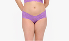 Woman wearing a purple lingerie set on a white background