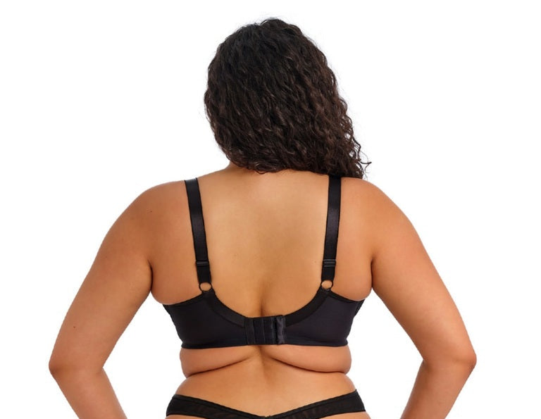 Person wearing a black lingerie set on a white background