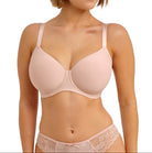 Woman wearing a beige bra and underwear set on a white background