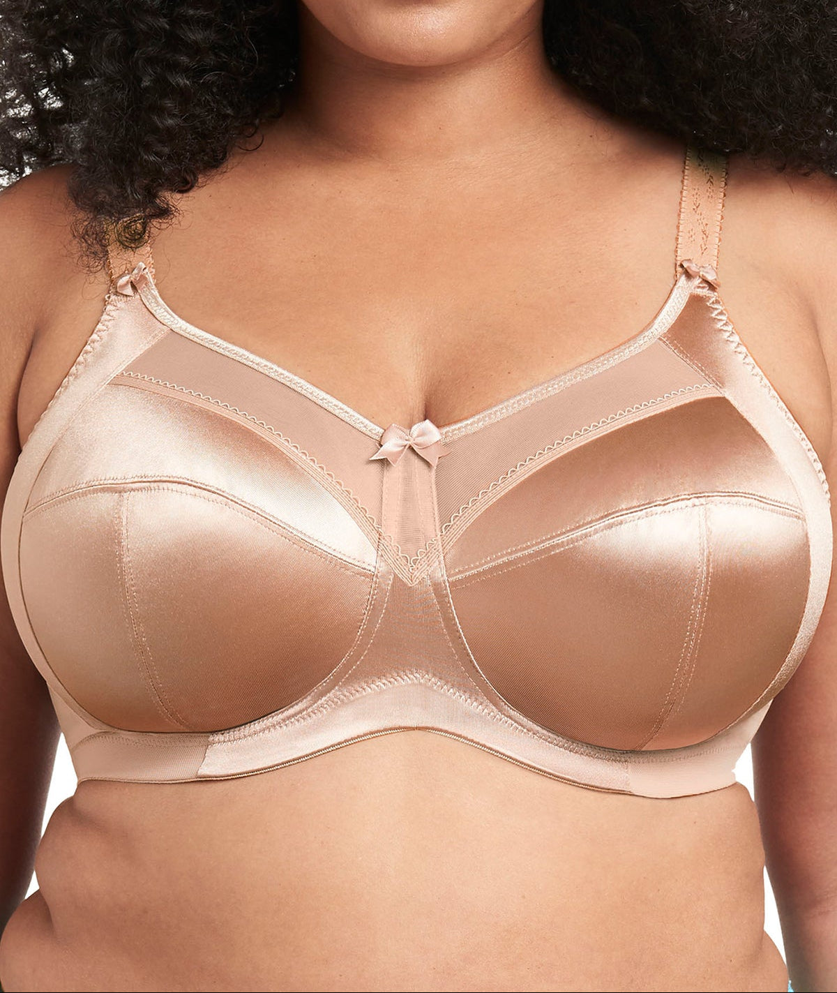 Woman wearing a beige bra with a neutral background
