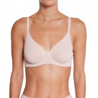 Woman wearing a beige bra on a white background