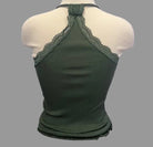 Green lace-trimmed top on a mannequin against a neutral background