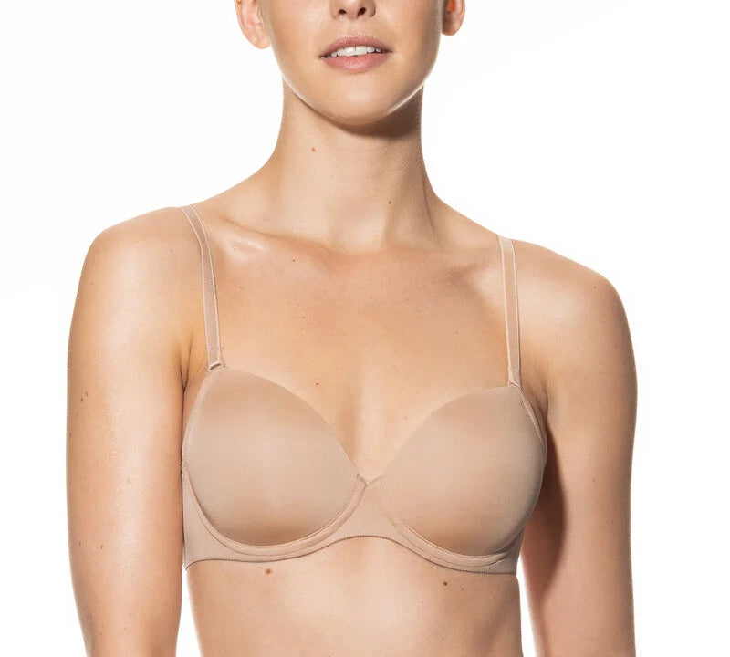 Woman wearing a beige bra on a white background