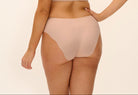 Woman wearing a beige bikini set on a plain background