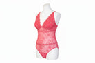 Pink lace lingerie set on a mannequin against a white background