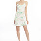 woman looks chic on vacation styling a tropical printed silk nightgown as a dress