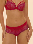 Red lace lingerie set on a beige background