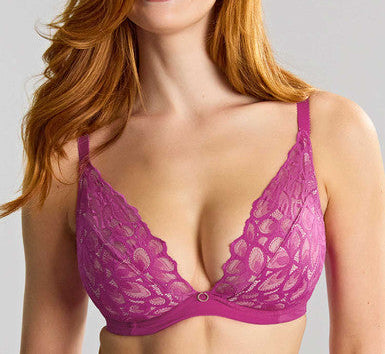 Woman wearing a purple lace bra against a plain background