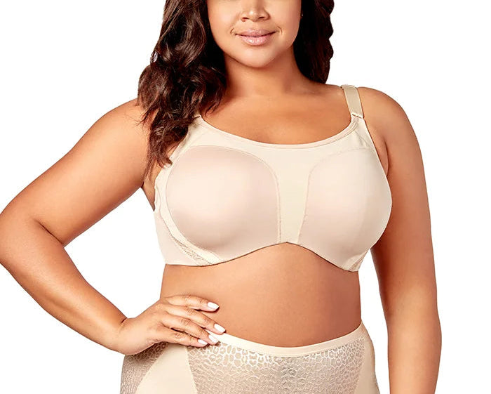 Woman wearing a beige bra and high-waisted underwear set on a white background
