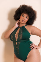 Full figured African American woman flaunts an emerald green bodysuit
