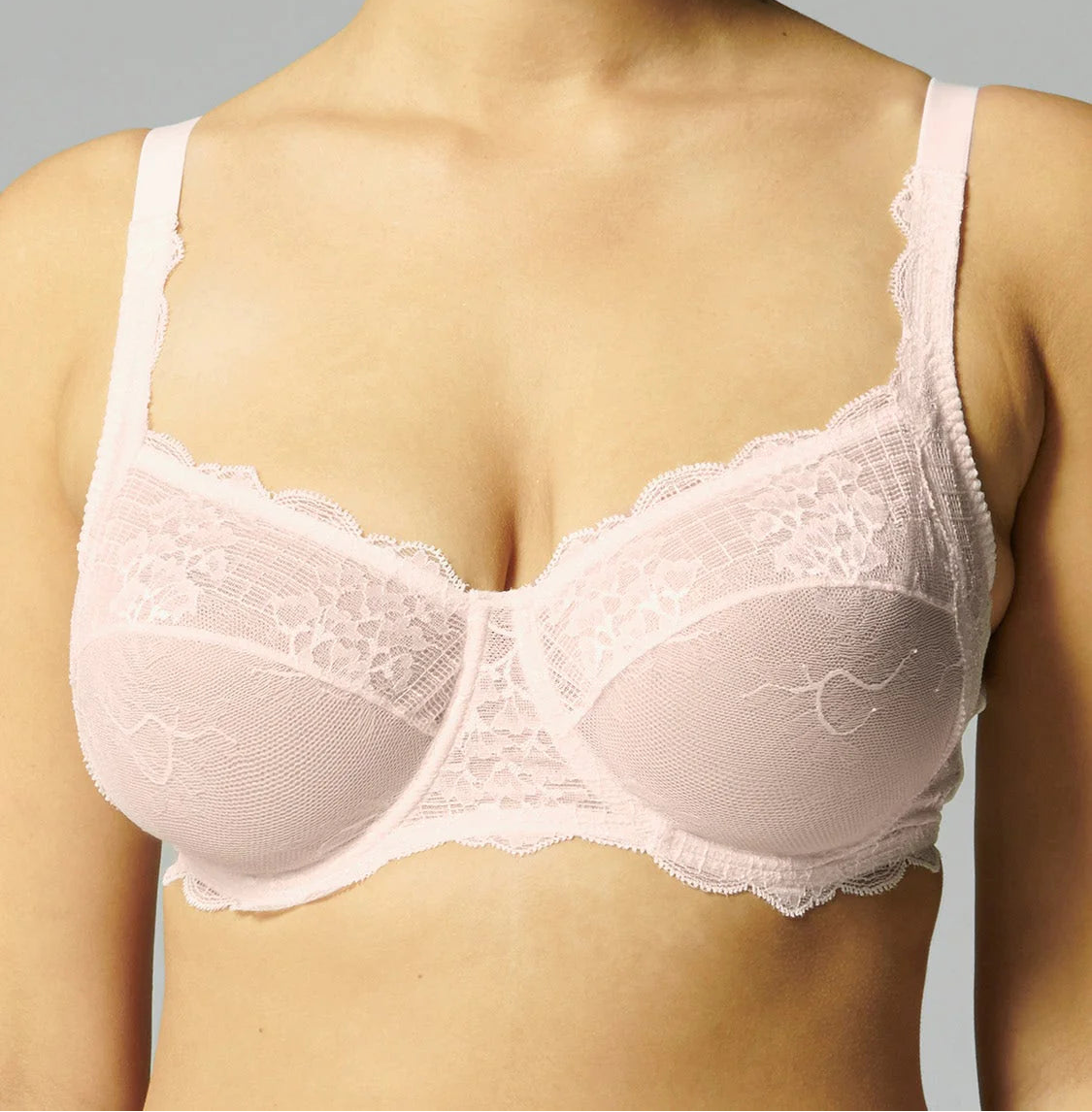 This image features the "Reve Full Cup" bra, presented in a delicate and sophisticated design. The bra is crafted with a soft, blush pink hue and adorned with intricate lace detailing along the cups, enhancing its elegant appearance.
